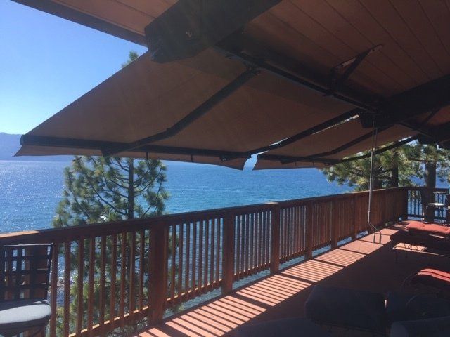 Awning covering a back deck overlooking a lake