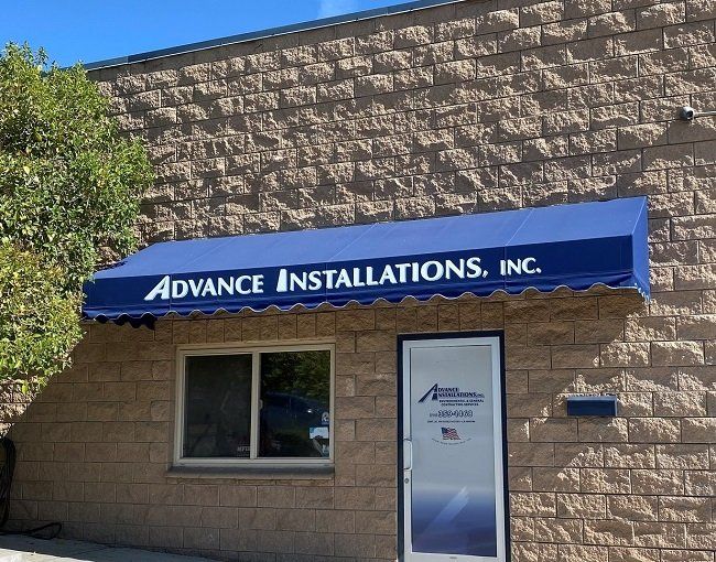 Advance Installations Inc. Awning over front door of their store